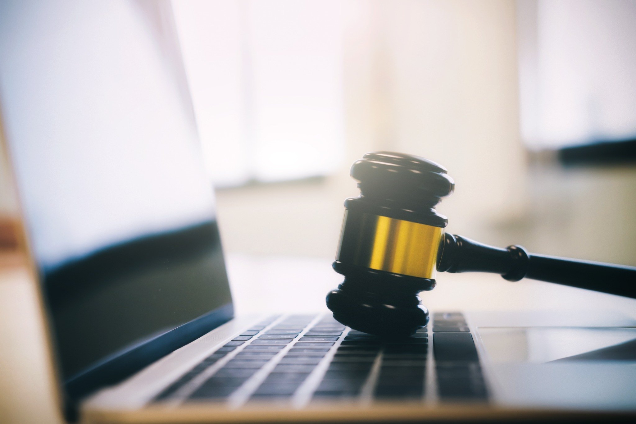 Gavel on laptop keyboard representing governance documentation